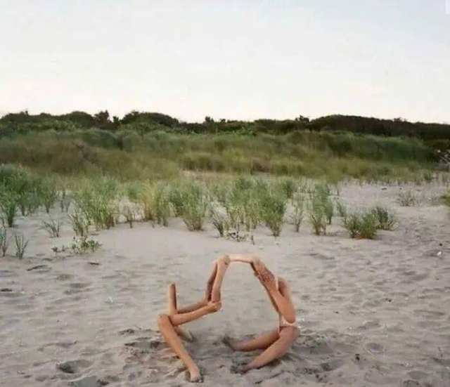 Two people holding reflective mirrors outdoors.