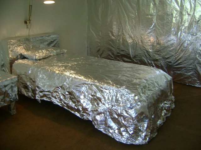 Furniture wrapped completely in silver foil.