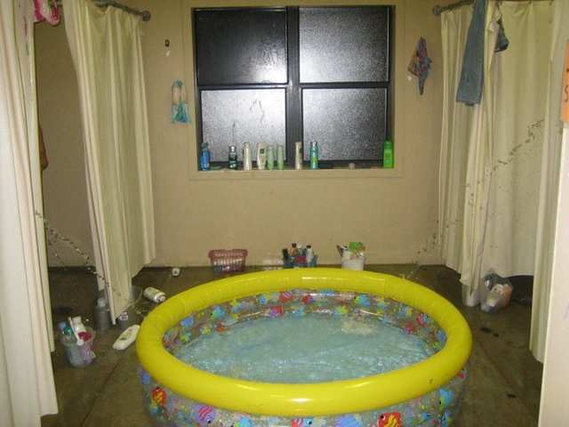 Inflatable pool set up inside a living room.