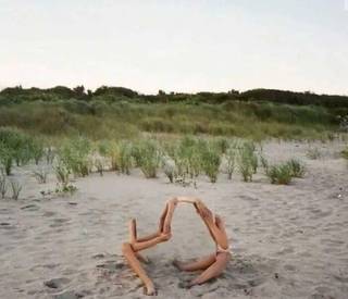 Two people holding reflective mirrors outdoors.