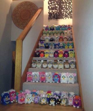 A staircase is packed with rows of plush toys and faces.