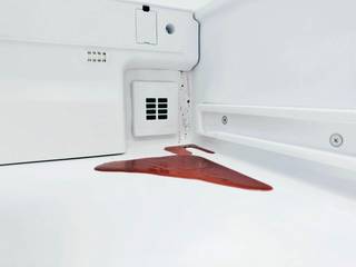 A red beetroot spill pools inside a white refrigerator.