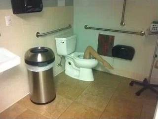 Public restroom with a plank across the toilet.