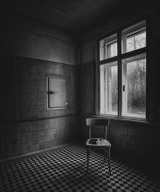 An abandoned interior photographed in black and white.