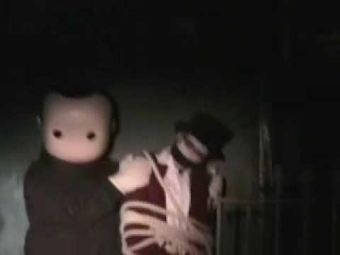 Two small figures posed in darkness.