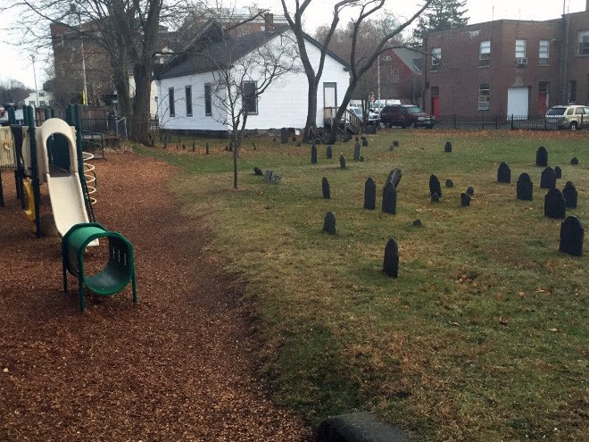 Tiny grave markers scattered across a yard.