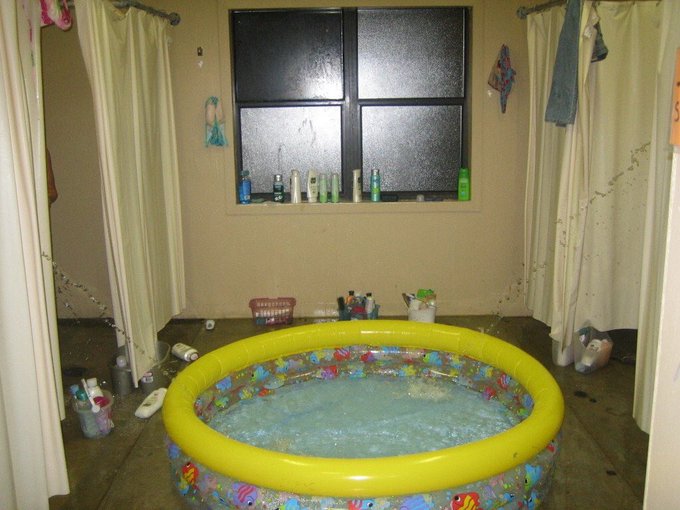 Inflatable pool set up inside a living room.
