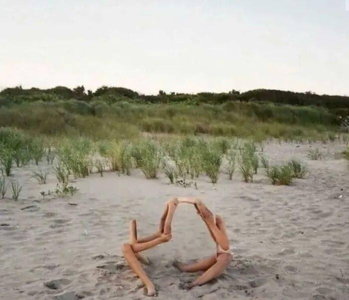 Two people holding reflective mirrors outdoors.