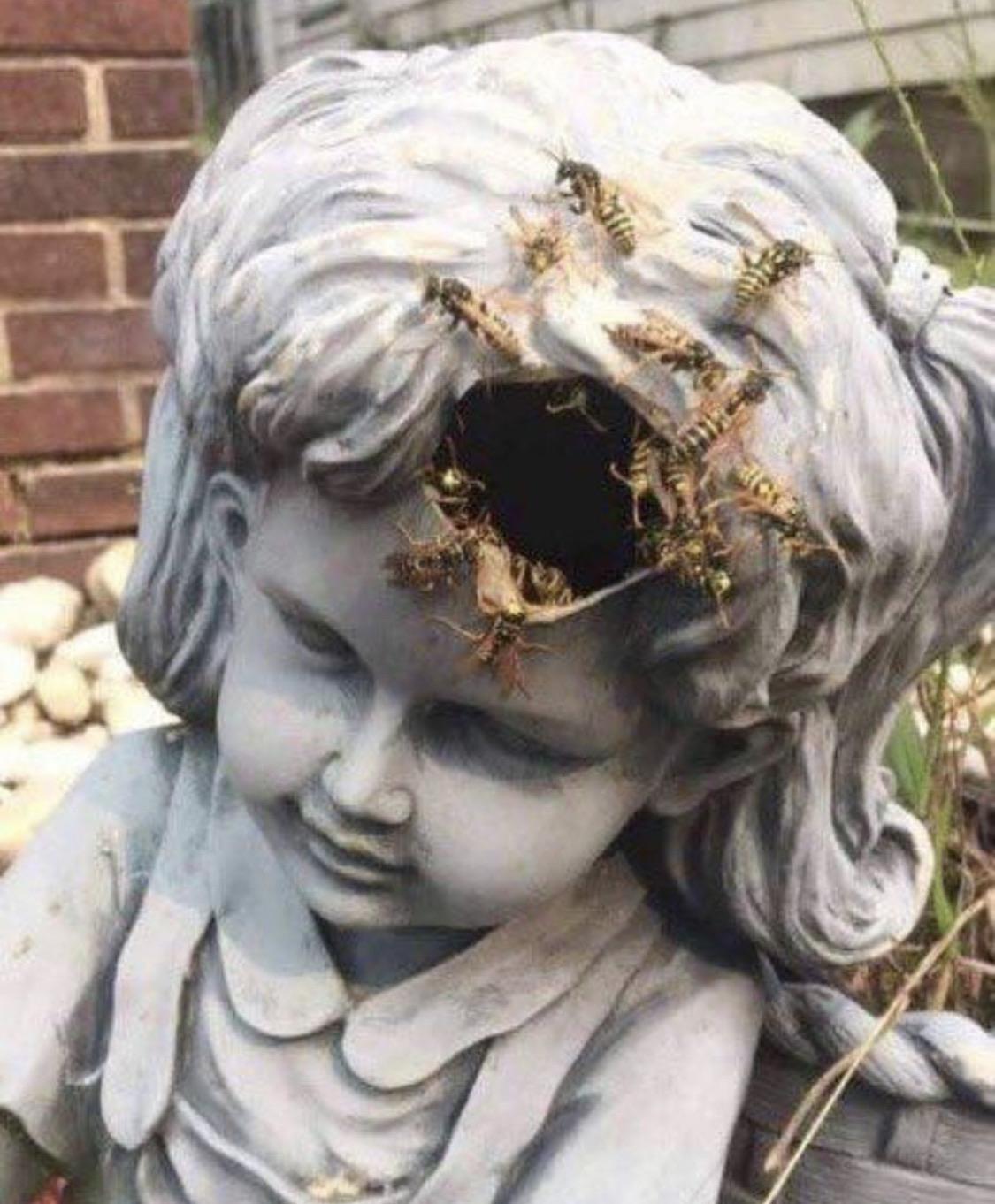 Weathered statue face close-up.