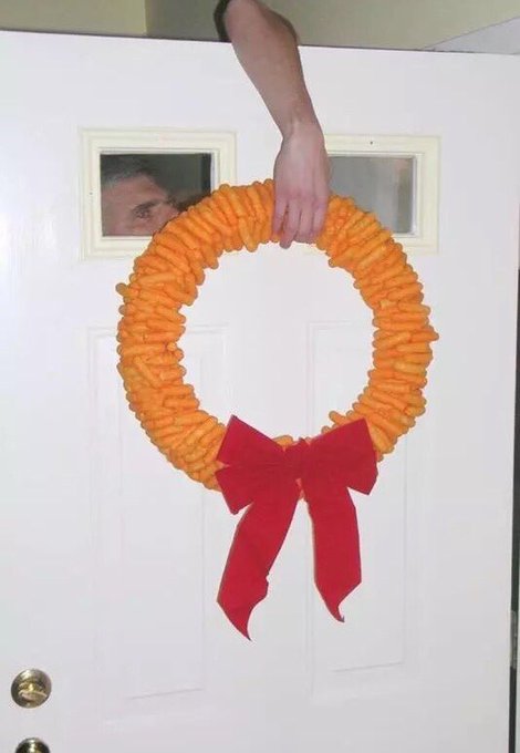 A bright wreath is paired with a fleshy fake hand.