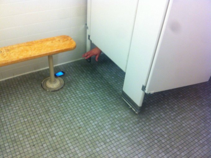 Corn dog mounted inside a bathroom stall.