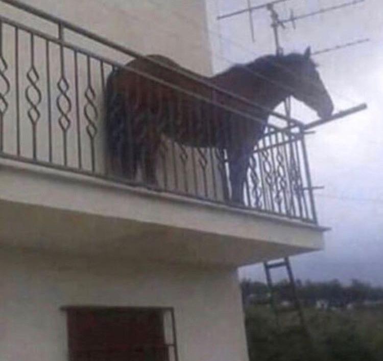 Odd object jutting from a balcony.