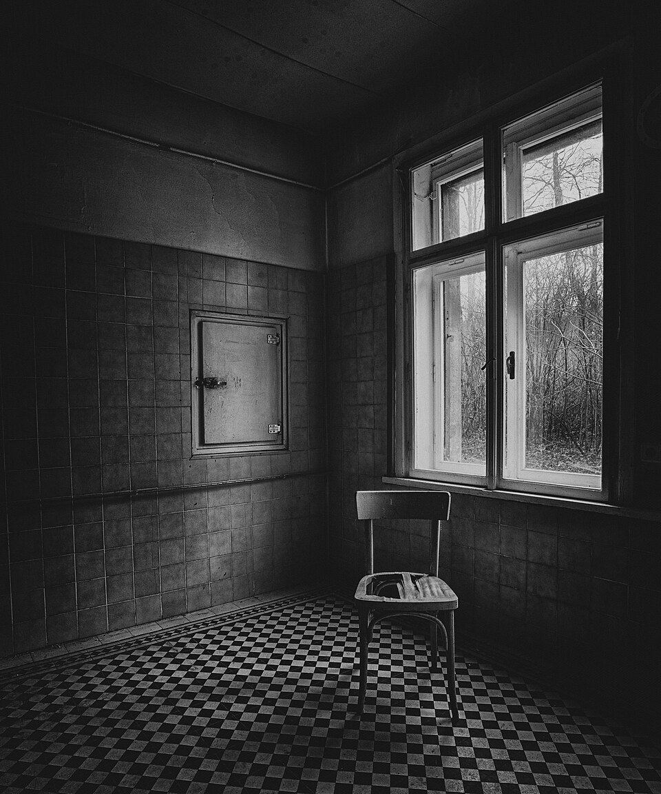 An abandoned interior photographed in black and white.