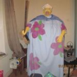 Unsettling DIY clown costume with a floral design and eerie expression.