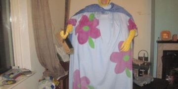 Unsettling DIY clown costume with a floral design and eerie expression.
