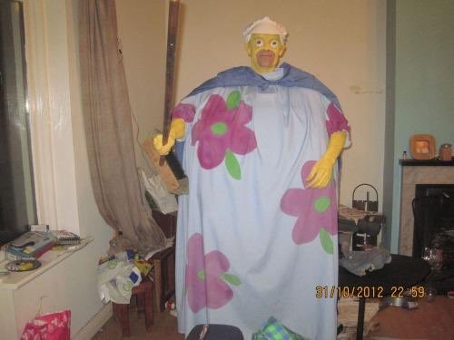 Unsettling DIY clown costume with a floral design and eerie expression.