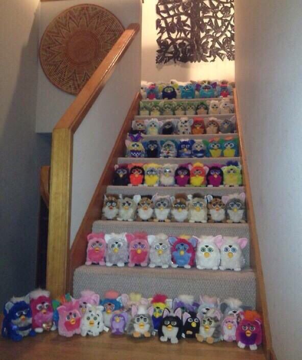 The Staircase of Furbies: Cute or Cursed? 4 A staircase filled with rows of Furbies neatly organized by color.