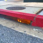 Fire Burning Beneath a Sidewalk Drain